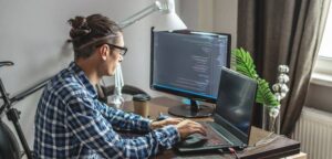 stock photo male programmer writing program code laptop home remote work profession 300x144 - Топ 15 онлайн – профессий, которые будут актуальны ближайшие 10 лет